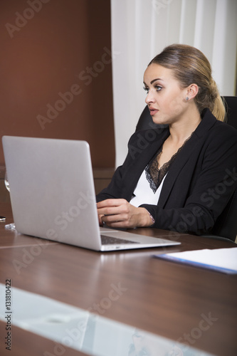 Beautiful blonde woman listening on a business meeting.