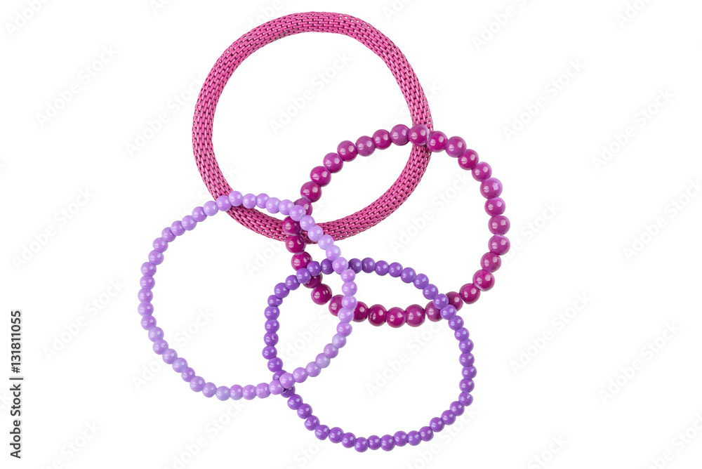 Set of three purple elastic bracelets made of pearl-like round beads and one purple metallic elastic bracelet, isolated on white background, clipping path included Set of three purple elastic bracelets made of pearl-like round beads and one purple metallic elastic bracelet, isolated on white background, clipping path included
