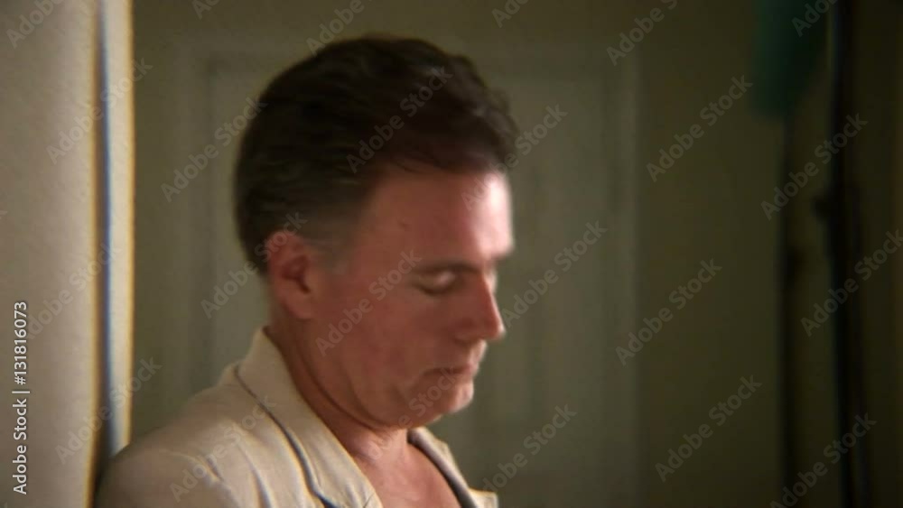 man opens his mail to find some bad news or un-paid bills man opens his mail to find some bad news or un-paid bills