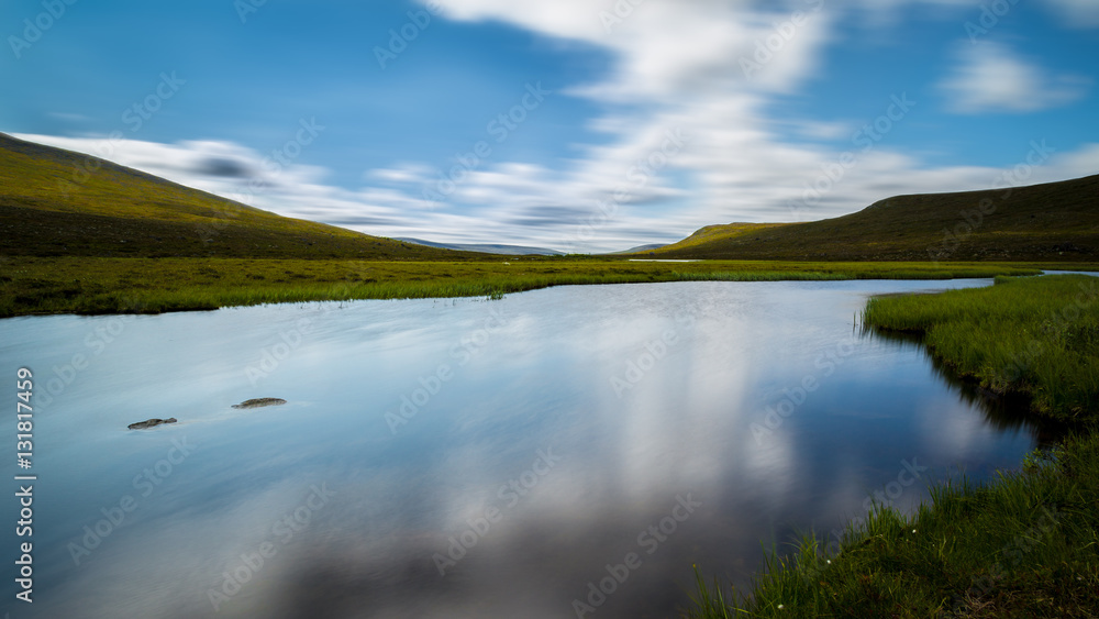 River running with green mountains on both sides