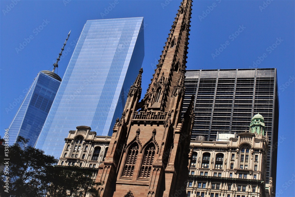 Naklejka premium New York City; Looking upwards on Broadway at Trinity Church