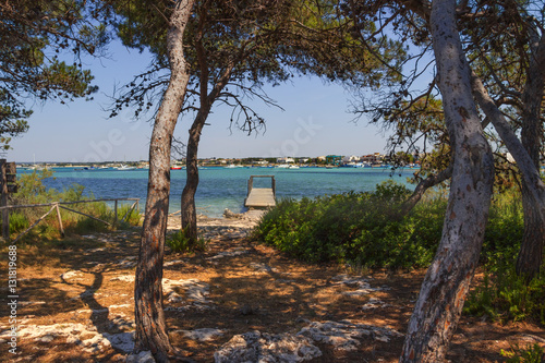Summer holidays.Ionian coast of Salento:Porto Cesareo (Lecce).- ITALY (Apulia) -In the background Porto Cesareo town seen from the Big Island (or Isola Grande) Nature Reserve.