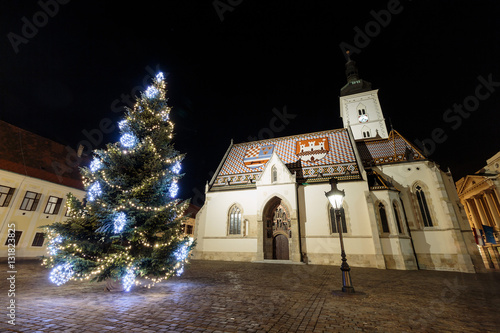 Saint Marks square and st. Mark church with Christmas tree in front of it as part of Advent in Zagreb, Croatia