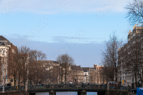 Netherlands, Amsterdam - canal  with typical houses against blue © Studio Dagdagaz