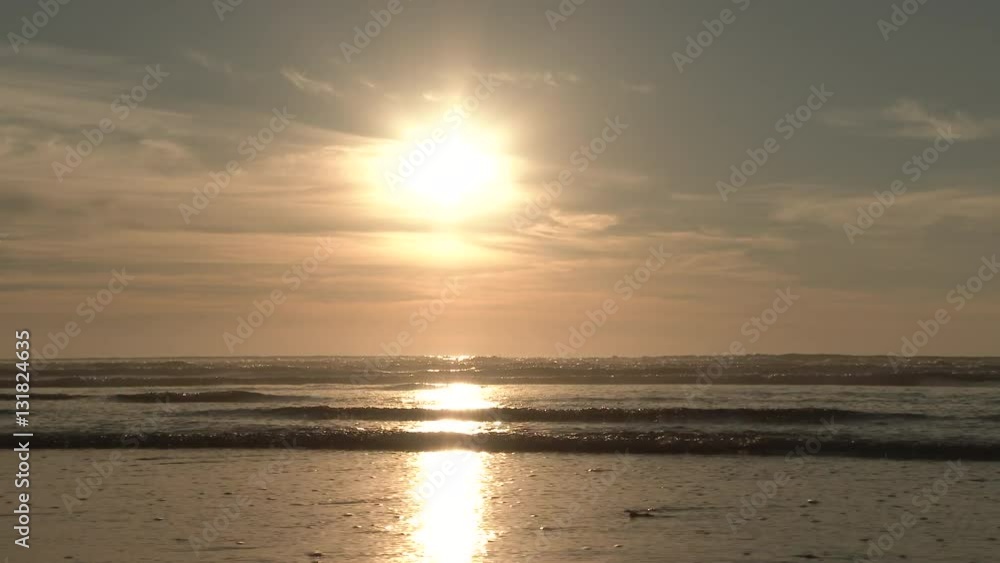 The tide recedes at the Oregon Coast during peaceful sunset with no people in sight. The tide recedes at the Oregon Coast during peaceful sunset with no people in sight.