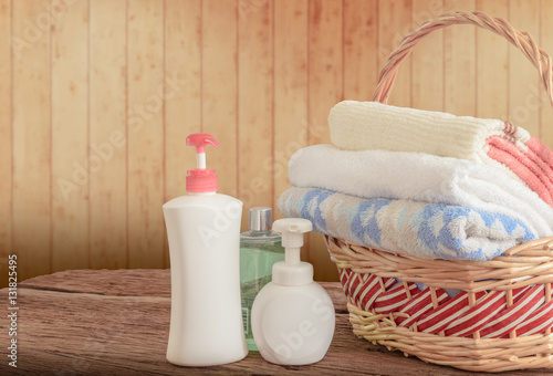 Shower gel with Skin cream and bath towels in basket