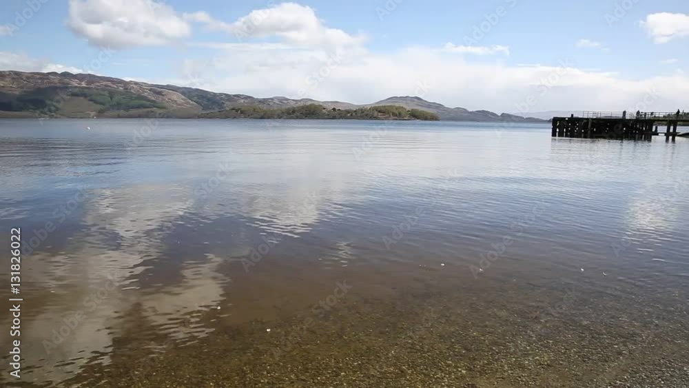 Loch Lomond Scotland UK in summer with clear water mountains and jetty popular Scottish tourist destination pan Loch Lomond Scotland UK in summer with clear water mountains and jetty popular Scottish tourist destination pan