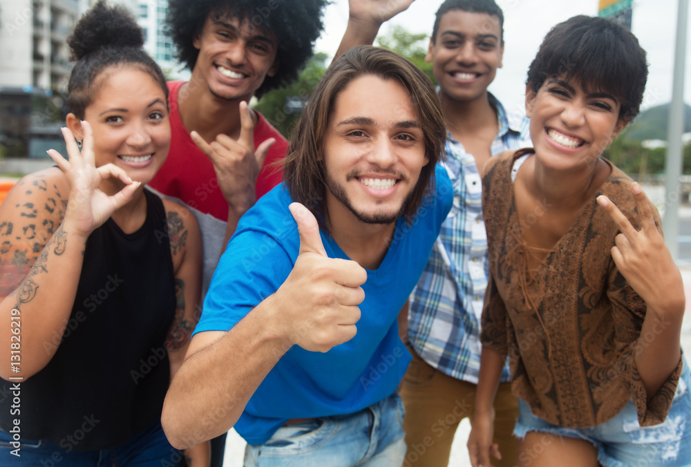 Obraz premium Group of international hipster young adults showing thumb
