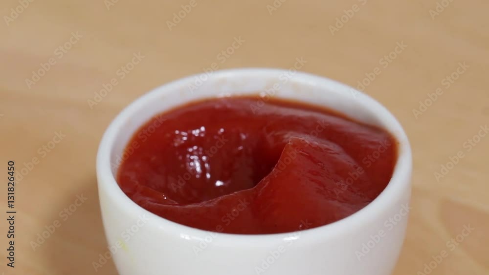 Dipping Chicken Crossie into Tomato Ketchup, Closeup, low focus Dipping Chicken Crossie into Tomato Ketchup, Closeup, low focus
