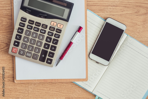 clipboard with a pen and notebook, calculator