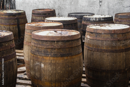 A collection of old and used wooden barrels.