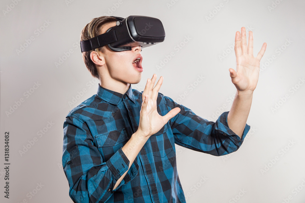 emotional funny man wearing virtual reality goggles. Studio portrait of video game designer wearing VR headset. studio shot isolated on gray background. emotional funny man wearing virtual reality goggles. Studio portrait of video game designer wearing VR headset. studio shot isolated on gray background.