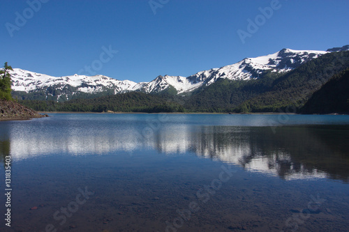 Reflection of the snow-covered mountains in the lake in the Conguillío National Park in Chile