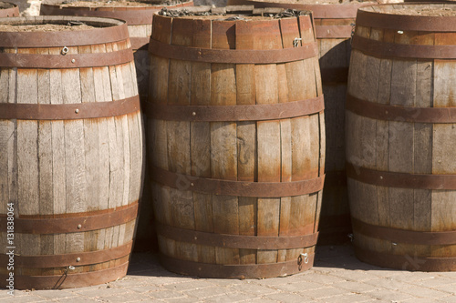 closeup of a row showing three wooden barrels © bwild