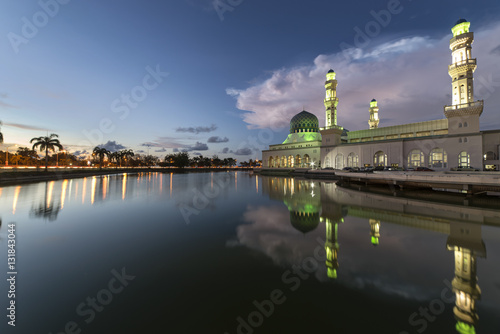 Beautiful twilight view City mosque in Kota Kinabalu, Sabah Borneo. Long exposure photograph with grain. Image contain certain grain or noise and soft focus. © joulesorubou