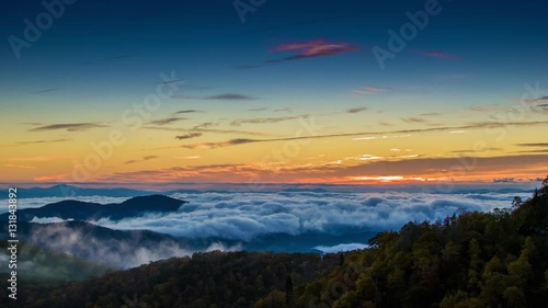 Early Morning Scene Overlooking from the Blue Ridge Parkway near Asheville NC with Fast Moving Mist and Clouds covering the Appalachian Mountain Peaks during the Fall