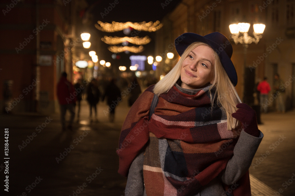 young smiling girl outdoors winter street night