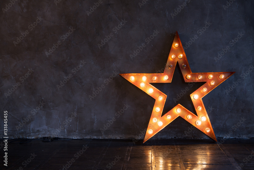 Decorative star with lamps on a background of wall. Modern grungy interior

 - obrazy, fototapety, plakaty 