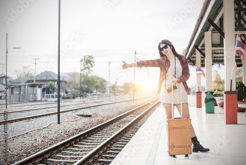Hipster girl waiting train with leather vintage bag