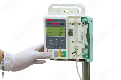 Hand and white medical gloves of doctor control IV on infusion pump on white background.Save with clipping path.