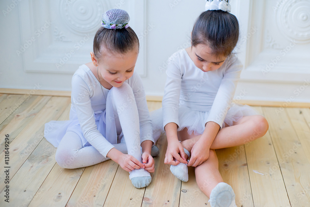 Fototapeta premium Two young ballet dancers preparing for lesson