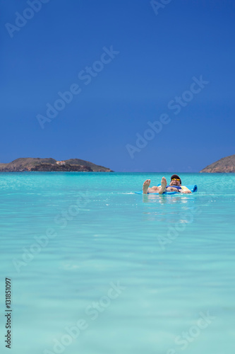 Total relaxation as a man drifts off on the calm waters of tropical Magens Bay, St. Thomas