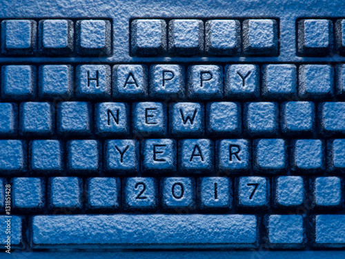 keyboard with inscription Happy New Year 2017 illuminated by blue light