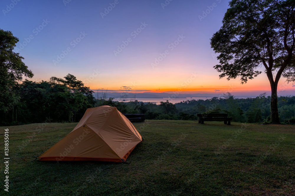 Tourist tent in camp among meadow in the mountain at sunrise
