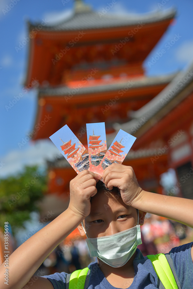 Asian boy holding tree ticket entrance of Kiyomizu-dera Temple i