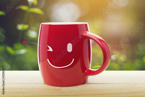 Brown mug of coffee with a happy smile
