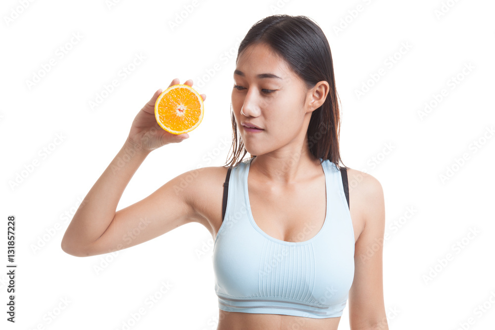 Beautiful Asian healthy girl with orange fruit licks her lips. Beautiful Asian healthy girl with orange fruit licks her lips.