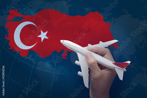 Obraz na płótnie hand holding airplane with map of Turkey. w salonie
