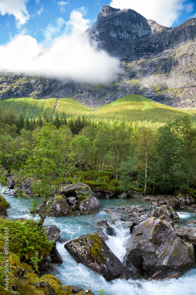 Norwegian landscape with milky blue glacier river near Trollstigen