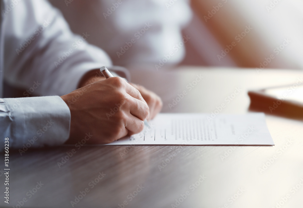 Businessman signing documents Businessman signing documents