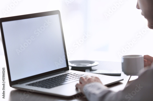 Businessman using laptop, closeup