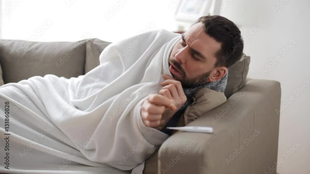 ill man with thermometer having flu at home ill man with thermometer having flu at home