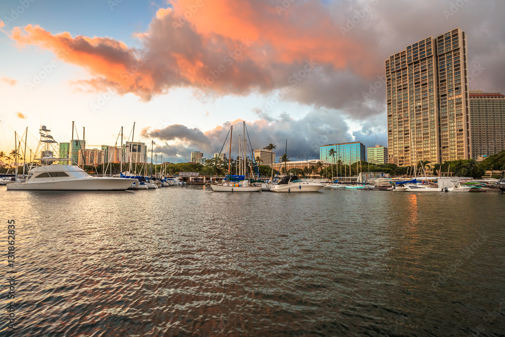 Skyline at sunset of Ala Wai Harbor the largest yacht harbor of Hawaii. Honolulu, Oahu in Hawaii, United States.