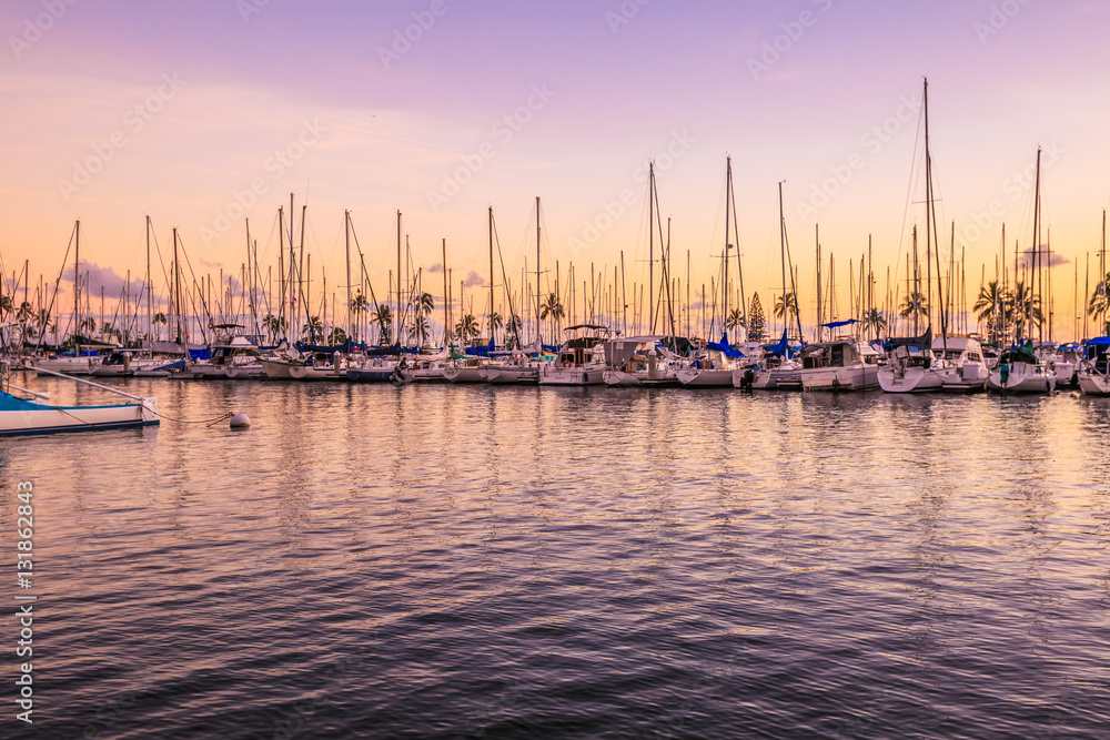 Beautiful skyline of fishing boats docked at the Ala Wai Harbor at twilight. Ala Wai Yacht Harbor is the largest yacht harbor of Hawaii, situated between Waikiki and downtown Honolulu.