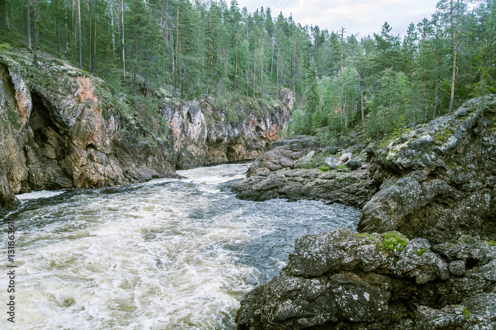 A beautiful scenery with a river rapids at the red cliffs in Finland A beautiful scenery with a river rapids at the red cliffs in Finland