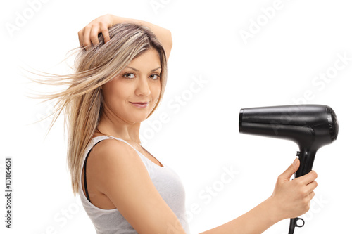Young woman using a hairdryer