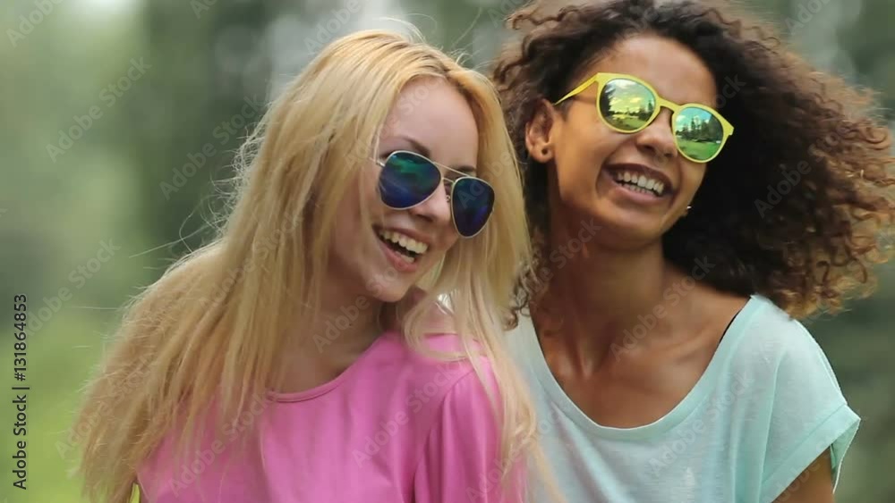 Two female friends dancing, looking and smiling at each other from time to time Two female friends dancing, looking and smiling at each other from time to time