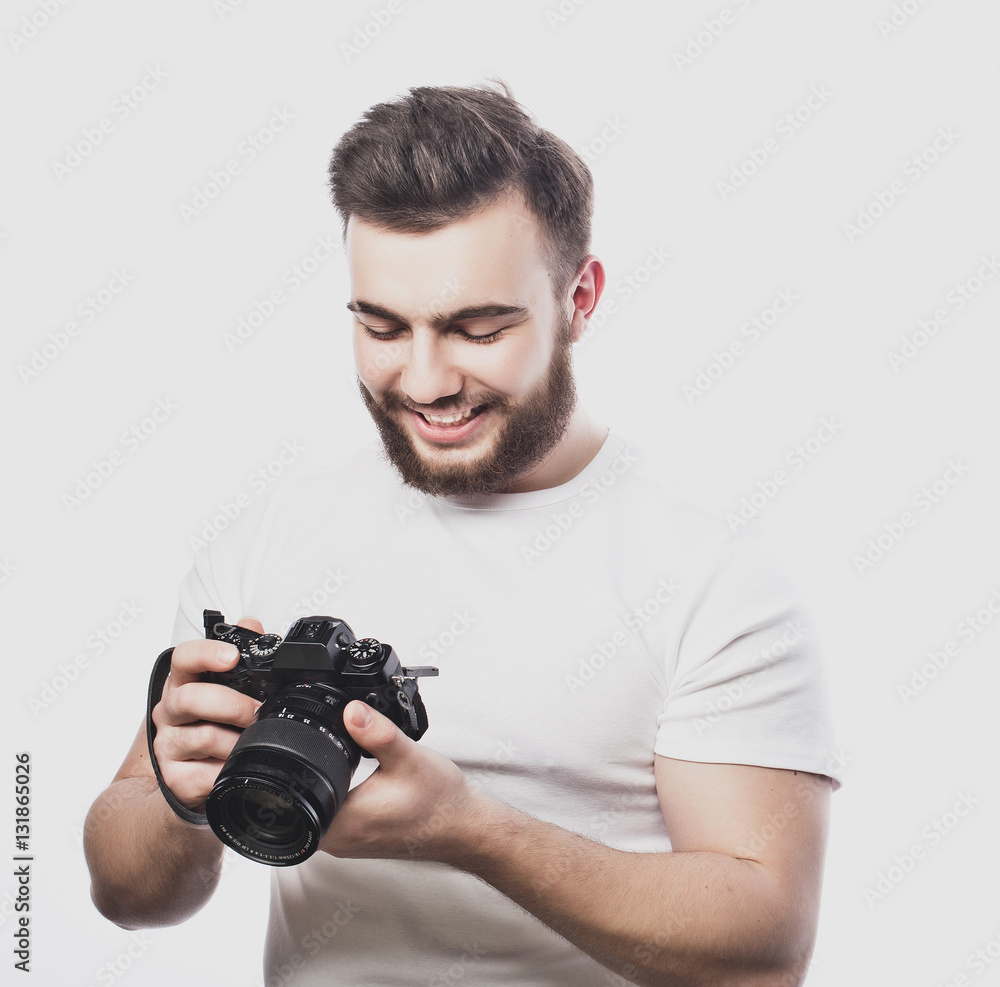 young bearded photographer taking pictures with digital camera. young bearded photographer taking pictures with digital camera.