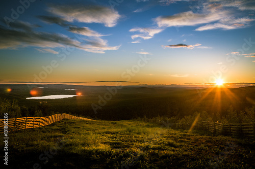 Canvastavla A beautiful landscape with a midnight sun above arctic circle
