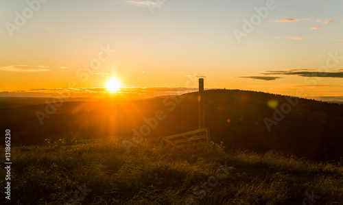 A beautiful landscape with a midnight sun above arctic circle. Dreamy scenery with light flares