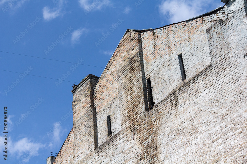 Old building facade with windows, on blue sky. Old building facade with windows, on blue sky.