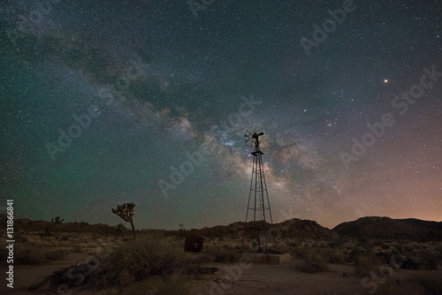 Fototapeta Milky Way Galaxy rising behind an old windmill