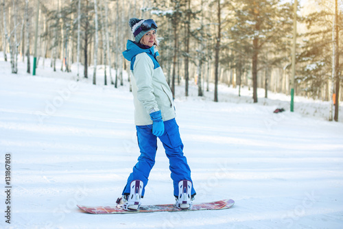 female snowboarder snowboarding down the mountain