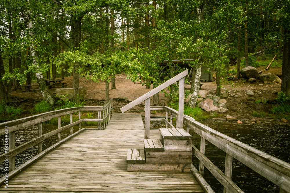 Obraz premium A beautiful lake landscape with footbridge in Finland