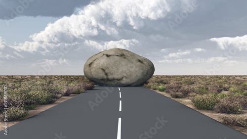 Felsbrocken versperrt den Weg auf einer Landstraße photo
