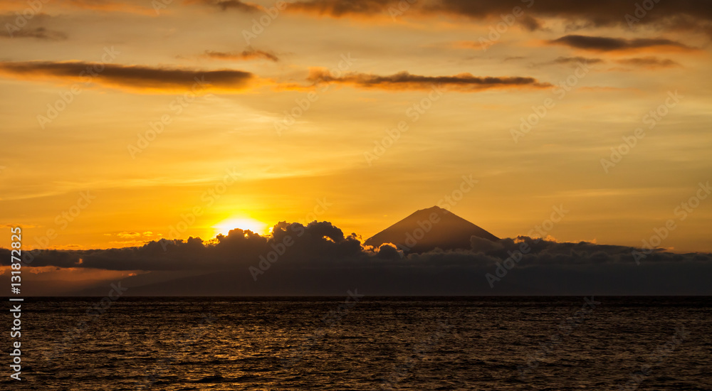 Sunset landscape with panoramic view of Bali Island and Agung Volcano mountain taken from Lombok Island, Indonesia Sunset landscape with panoramic view of Bali Island and Agung Volcano mountain taken from Lombok Island, Indonesia